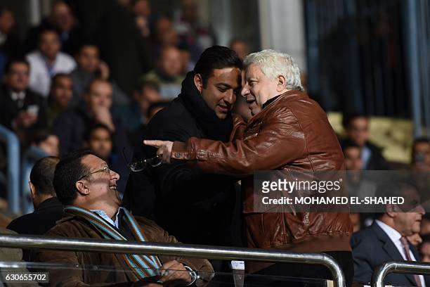 Chairman of Board of Directors of the club Zamalek Chancellor Mortada Mansour speaks with former Egyptian national team player Ahmed Hossam during...