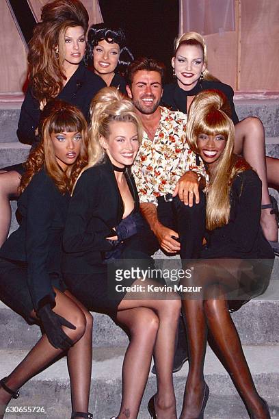 Tyra Banks, Linda Evangelista, George Michael and Eva Herzigova, Beverly Peele pose during the "Too Funky" video shoot circa 1992 in Paris, France.