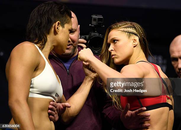 Women's bantamweight champion Amanda Nunes of Brazil and Ronda Rousey face off during the UFC 207 weigh-in at T-Mobile Arena on December 29, 2016 in...