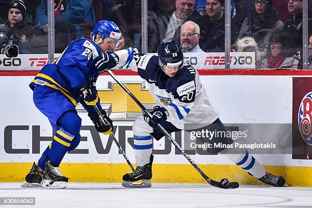 Julius Mattila of Team Finland defends the puck against Joel Eriksson Ek of Team Sweden during the 2017 IIHF World Junior Championship preliminary...