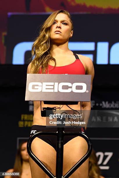 Ronda Rousey poses on the scale during the UFC 207 weigh-in at T-Mobile Arena on December 29, 2016 in Las Vegas, Nevada.