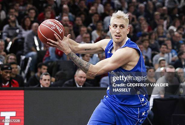 France's Paul Lacombe plays the ball during an All Star Game basketball match of the French Ligue Nationale de Basket between a selection of the best...