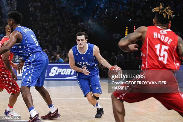 France's Axel Julien dribbles the ball during an All Star Game basketball match of the French Ligue Nationale de Basket between a selection of the...