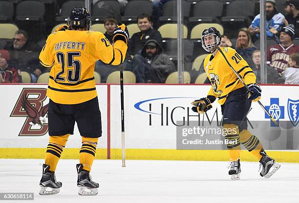 Craig Martin of the Quinnipiac Bobcats celebrates his goal with Brogan Rafferty in the third period during game one of the Three Rivers Classic...