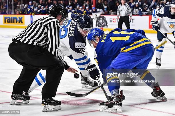 Aapeli Rasanen of Team Finland and Rasmus Asplund of Team Sweden face-off during the 2017 IIHF World Junior Championship preliminary round game at...