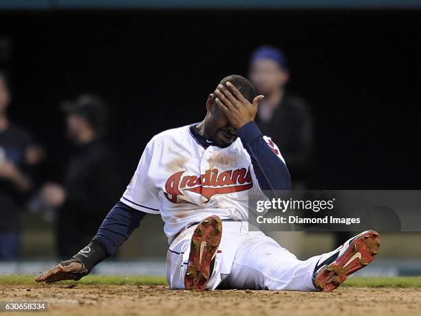 Centerfielder Michael Bourn of the Cleveland Indians sits after being injured while sliding into home plate during a game against the Toronto Blue...