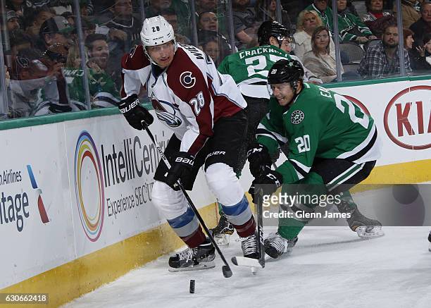 Patrick Wiercioch of the Colorado Avalanche tries to keep the puck away against Cody Eakin of the Dallas Stars at the American Airlines Center on...