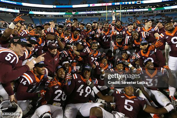 The Virginia Tech Hokies celebrate after defeating the Arkansas Razorbacks 35-24 in the Belk Bowl at Bank of America Stadium on December 29, 2016 in...