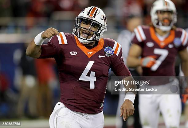 Jerod Evans of the Virginia Tech Hokies celebrates after a touchdown against the Arkansas Razorbacks during the Belk Bowl at Bank of America Stadium...