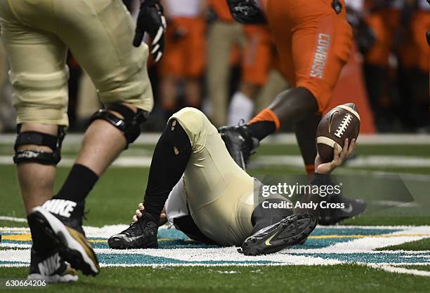 December 29: Colorado Buffaloes quarterback Sefo Liufau grabs his ankle after a short gain against Oklahoma State in the second quarter and had to...