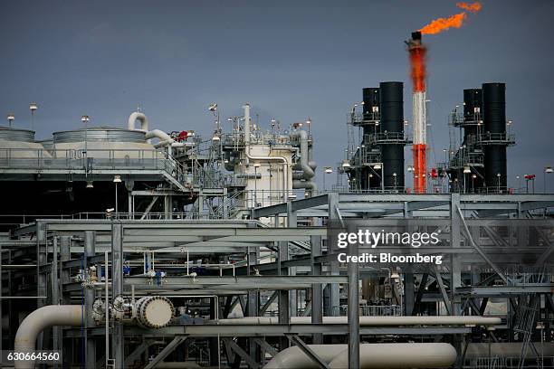 Flame blazes on top of a flare stack at the Queensland Curtis Liquefied Natural Gas project site, operated by QGC Pty, a unit of Royal Dutch Shell...