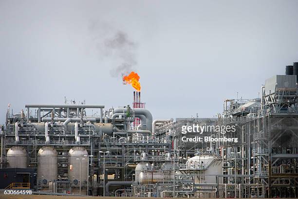 Flame blazes on top of flare stacks at a plant at the Queensland Curtis Liquefied Natural Gas project site, operated by QGC Pty, a unit of Royal...