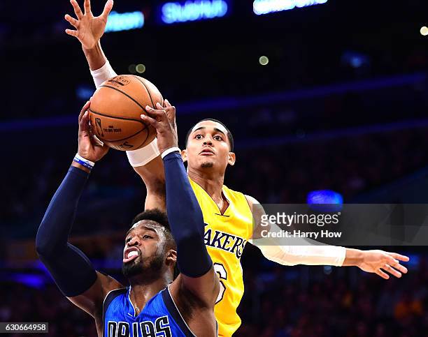 Jordan Clarkson of the Los Angeles Lakers attempts to block the shot of Wesley Matthews of the Dallas Mavericks during the first half at Staples...