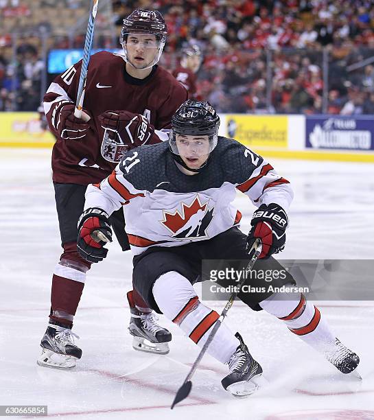 Blake Speers of Team Canada skates against Martins Dzierkals of Team Latvia during a preliminary game in the 2017 IIHF World Junior Hockey...