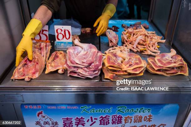 Fresh chicken meat sits on display in a live chicken shop in the Wanchai markets of Hong Kong on December 30, 2016. Hong Kong on Friday confirmed its...