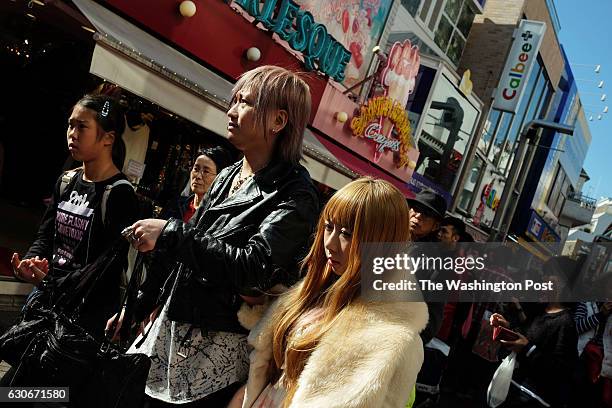 People make their way along a street in the Harajuku area on Friday November 04, 2016 in Tokyo, Japan.