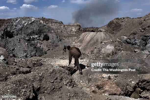 Creuseur, or digger, climbs through a copper and cobalt mine in Kawama, Democratic Republic of Congo on June 8, 2016. Cobalt is used in the batteries...