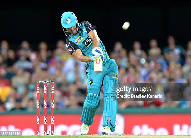 Chris Lynn of the Heat hits the ball over the boundary and on the roof of the stadium for a six during the Big Bash League between the Brisbane Heat...