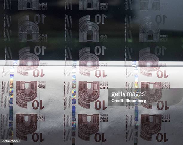 An intaglio printing plate, used for the printing of ten euro currency banknotes, and a sheet of printing paper sits on display inside the Deutsche...