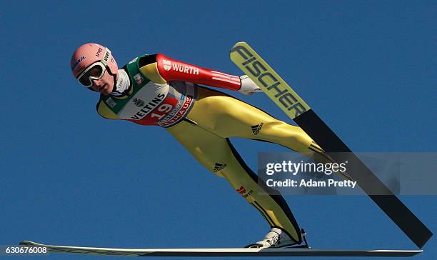 Severin Freund of Germany soars through the air during his training jump on Day 2 of the 65th Four Hills Tournament ski jumping event on December 30,...