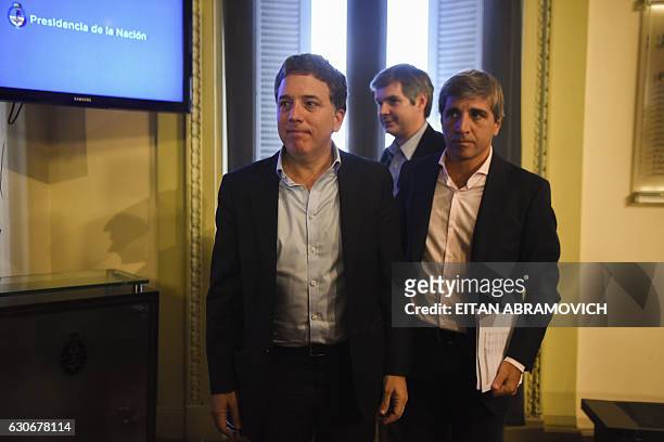Argentina's new Finance Minister Nicolas Dujovne and Budget Minister Luis Caputo leave after offering a press conference along with Chief Cabinet...