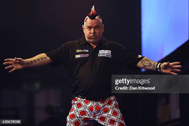 Peter Wright from Scotland celebrates after throwing a 180 during the quarter final of 2016 William Hill World Darts Championship on December 30,...