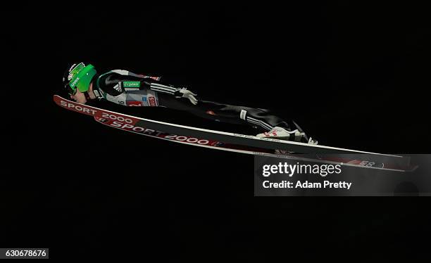 Jurij Tepes of Slovenia soars through the air during his first competition jump on Day 2 of the 65th Four Hills Tournament ski jumping event on...