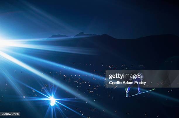 Michael Hayboeck of Austria soars through the air during his first competition jump on Day 2 of the 65th Four Hills Tournament ski jumping event on...