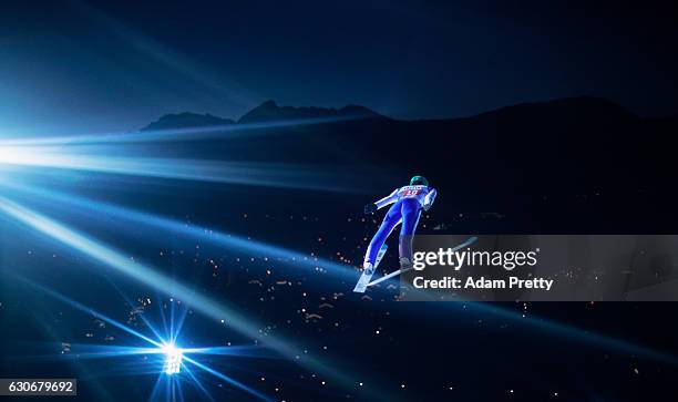 Peter Prevc of Slovenia soars through the air during his first competition jump on Day 2 of the 65th Four Hills Tournament ski jumping event on...