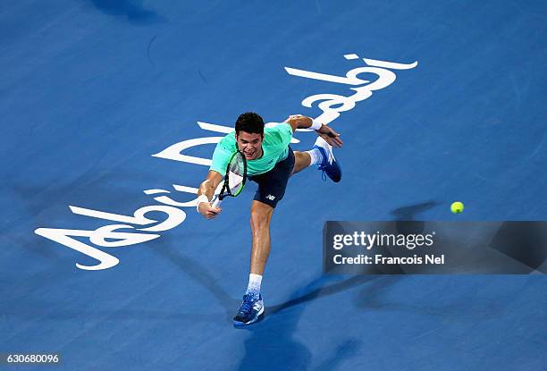 Milos Raonic of Canada in action against Rafael Nadal of Spain during day two of the Mubadala World Tennis Championship at Zayed Sport City on...