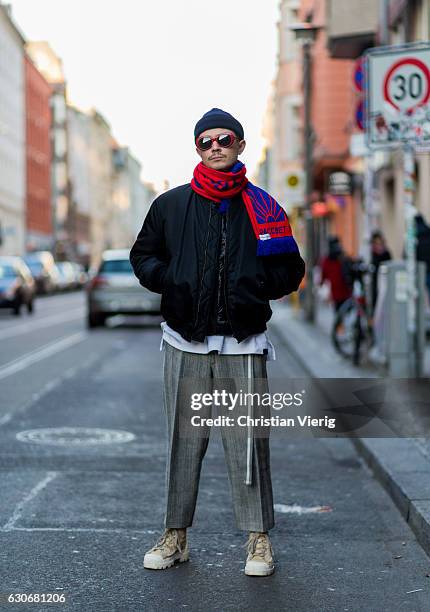 Pavel Kaczorowski wearing a red blue scarf Gosha Rubchinskiy, light beige white lace up boots Acne, black bomber jacket Givenchy, Saint Laurent...