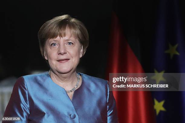 German Chancellor Angela Merkel poses for a photograph after the recording of her annual New Year's speech at the Chancellery in Berlin on December...