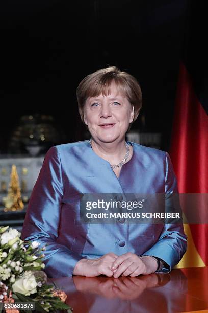 German Chancellor Angela Merkel poses for a photograph after the recording of her annual New Year's speech at the Chancellery in Berlin on December...