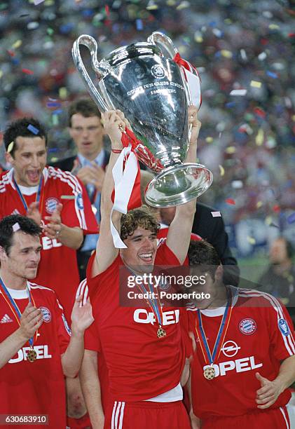 Owen Hargreaves of Bayern Munich lifts the Cup, as the team celebrate, at the conclusion of the UEFA Champions League Final between Bayern Munich and...