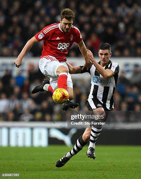 Nicklas Bendtner challenges Ciaran Clark during the Sky Bet Championship match between Newcastle United and Nottingham Forest at St James' Park on...