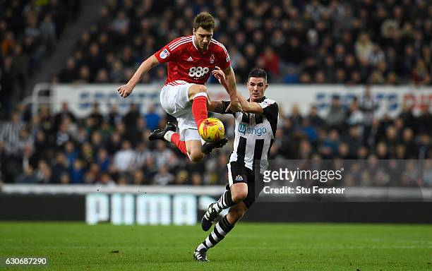 Nicklas Bendtner challenges Ciaran Clark during the Sky Bet Championship match between Newcastle United and Nottingham Forest at St James' Park on...