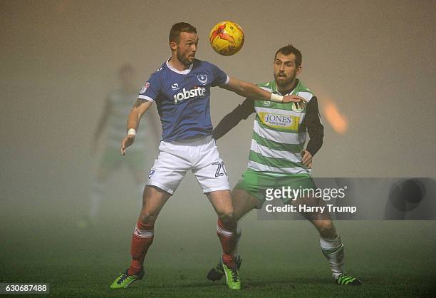 Noel Hunt of Portsmouth is tackled by Alex Lawless of Yeovil Town during the Sky Bet League Two match between Yeovil Town and Portsmouth at Hush Park...