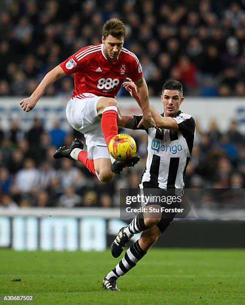 Nicklas Bendtner challenges Ciaran Clark of Newcastle during the Sky Bet Championship match between Newcastle United and Nottingham Forest at St...