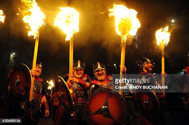 Members of the Up Helly AA Vikings from Shetland prepare to lead the torchlight procession through the streets of Edinburgh in Scotland on December...
