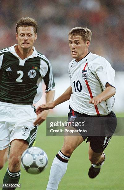 Michael Owen of England gets to the ball ahead of Christian Worns of Germany during the FIFA World Cup Qualifying match between Germany and England...