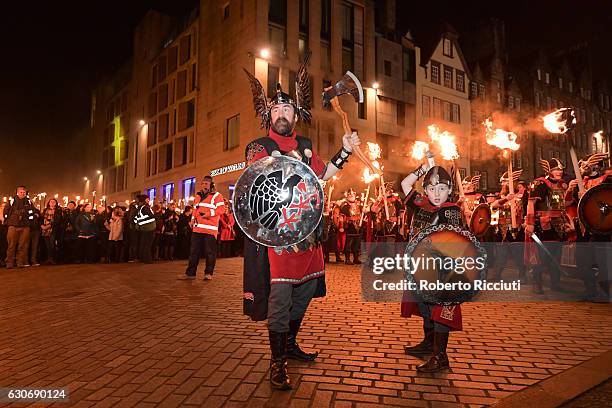 Men dressed as Vikings take part in the torchlight procession as it makes its way through Edinburgh for the start of the Hogmanay celebrations on...