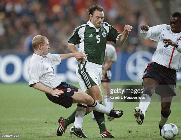 Jens Nowotny of Germany, is stopped by Paul Scholes and Emile Heskey of England, during the FIFA World Cup Qualifying match between Germany and...