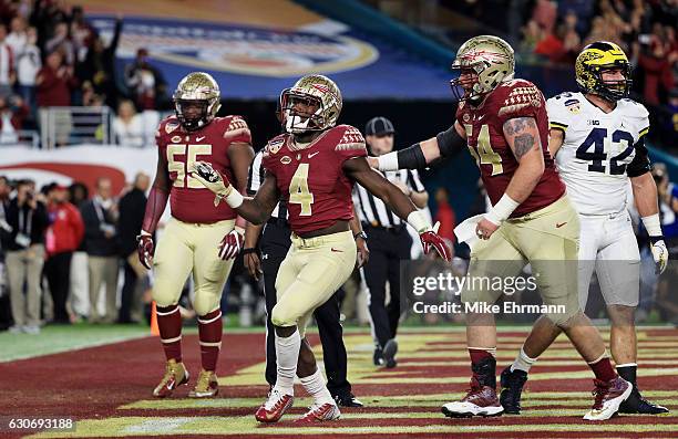 Dalvin Cook of the Florida State Seminoles celebrates his touchdown in the first quarter against the Michigan Wolverines during the Capitol One...