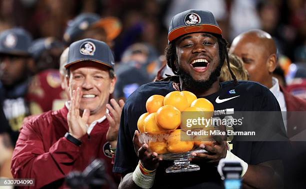 Dalvin Cook and head coach Jimbo Fisher of the Florida State Seminoles celebrate their 33 to 32 win over the Michigan Wolverines during the Capitol...