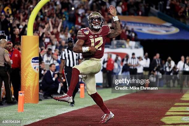 Deondre Francois of the Florida State Seminoles celebrates scoring a touchdown in the fourth quarteragainst the Michigan Wolverines during the...