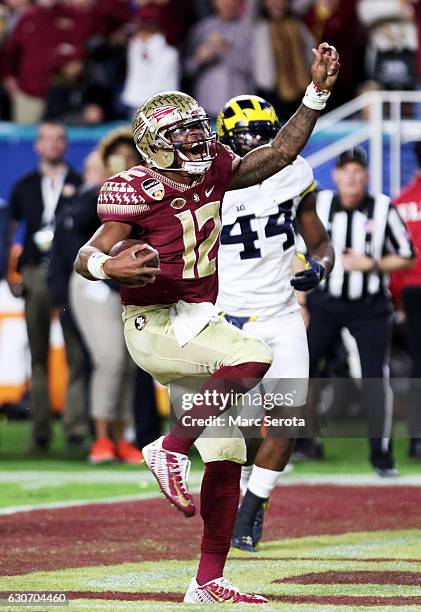 Deondre Francois of the Florida State Seminoles celebrates scoring a touchdown in the fourth quarteragainst the Michigan Wolverines during the...