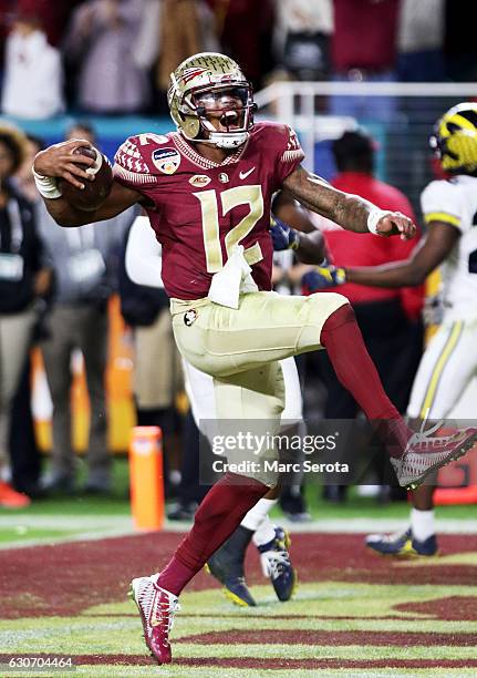 Deondre Francois of the Florida State Seminoles celebrates scoring a touchdown in the fourth quarteragainst the Michigan Wolverines during the...