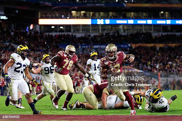 Deondre Francois of the Florida State Seminoles scores a touchdown in the fourth quarteragainst the Michigan Wolverines during the Capitol One Orange...