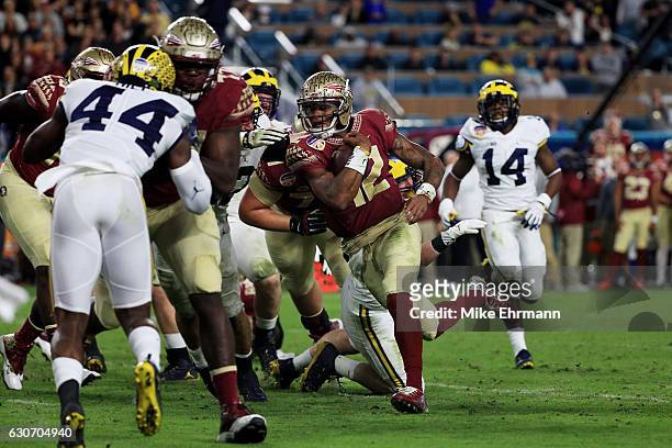 Deondre Francois of the Florida State Seminoles scores a touchdown in the fourth quarteragainst the Michigan Wolverines during the Capitol One Orange...