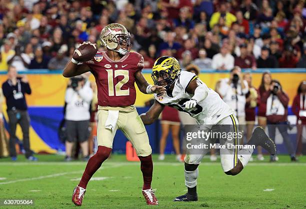 Deondre Francois of the Florida State Seminoles looks to pass under pressure in the second half during the Capitol One Orange Bowl at Sun Life...